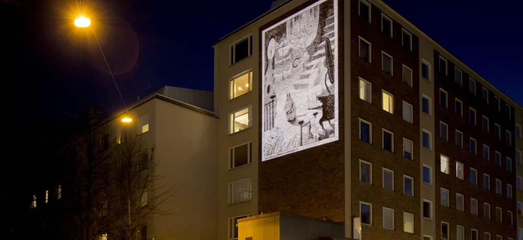 Moomin characters projected on a bulding's wall.